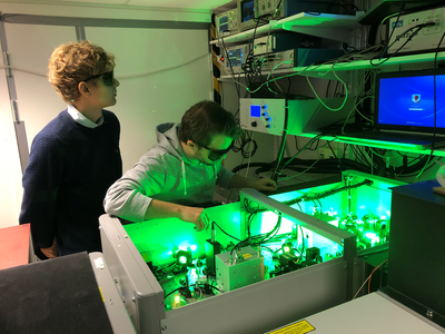 Scientists aligning a laser in the LLC attosecond science laboratory